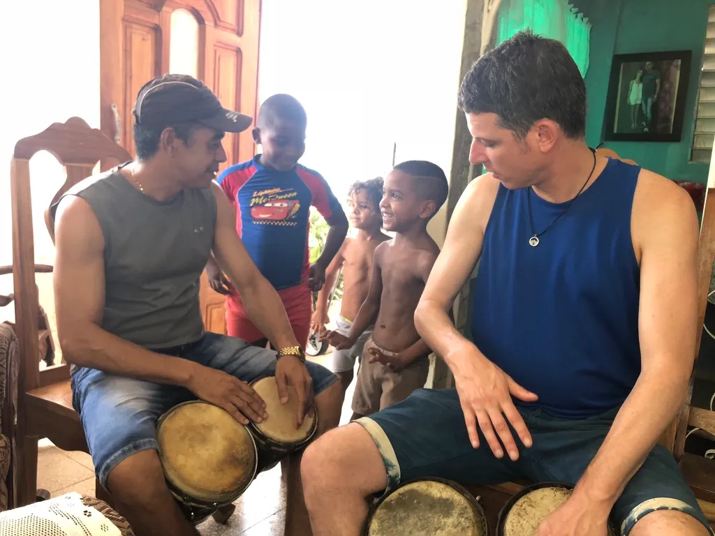 Michael and another percussionist sharing music with children nearby