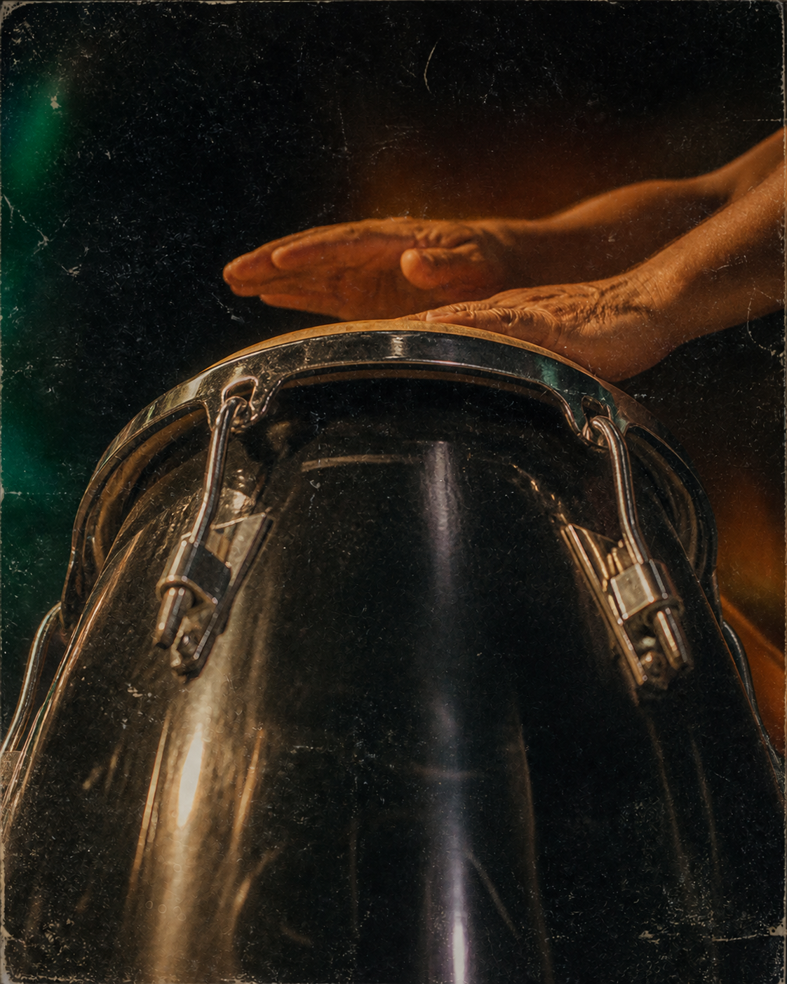 Hands playing a conga drum
